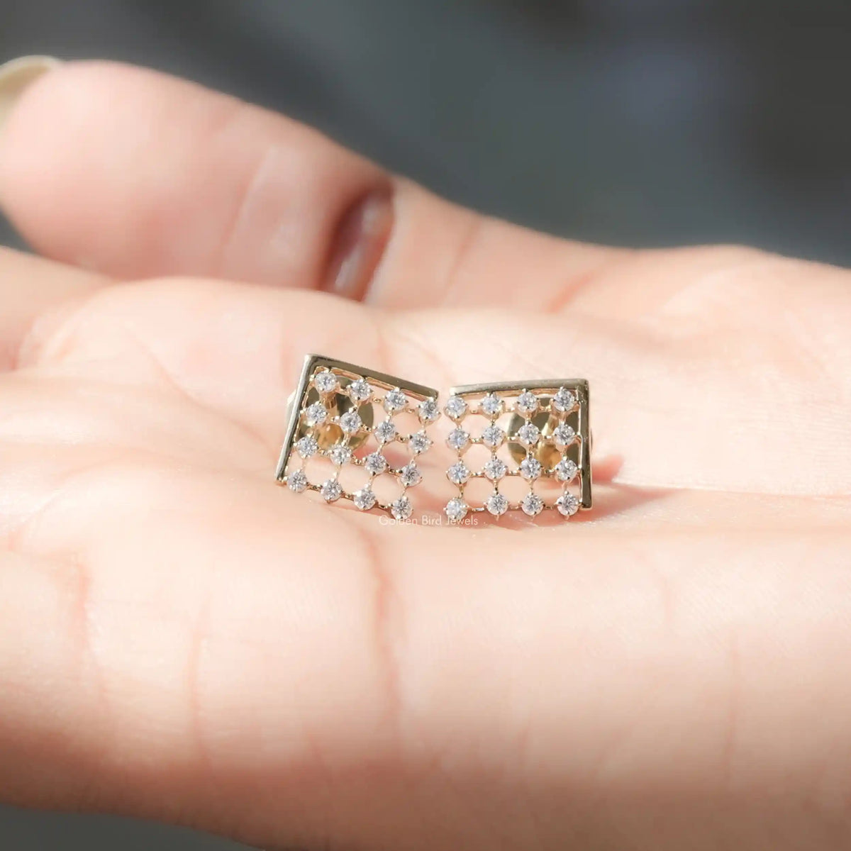 In Hand View Of round cut moissanite stud Earring