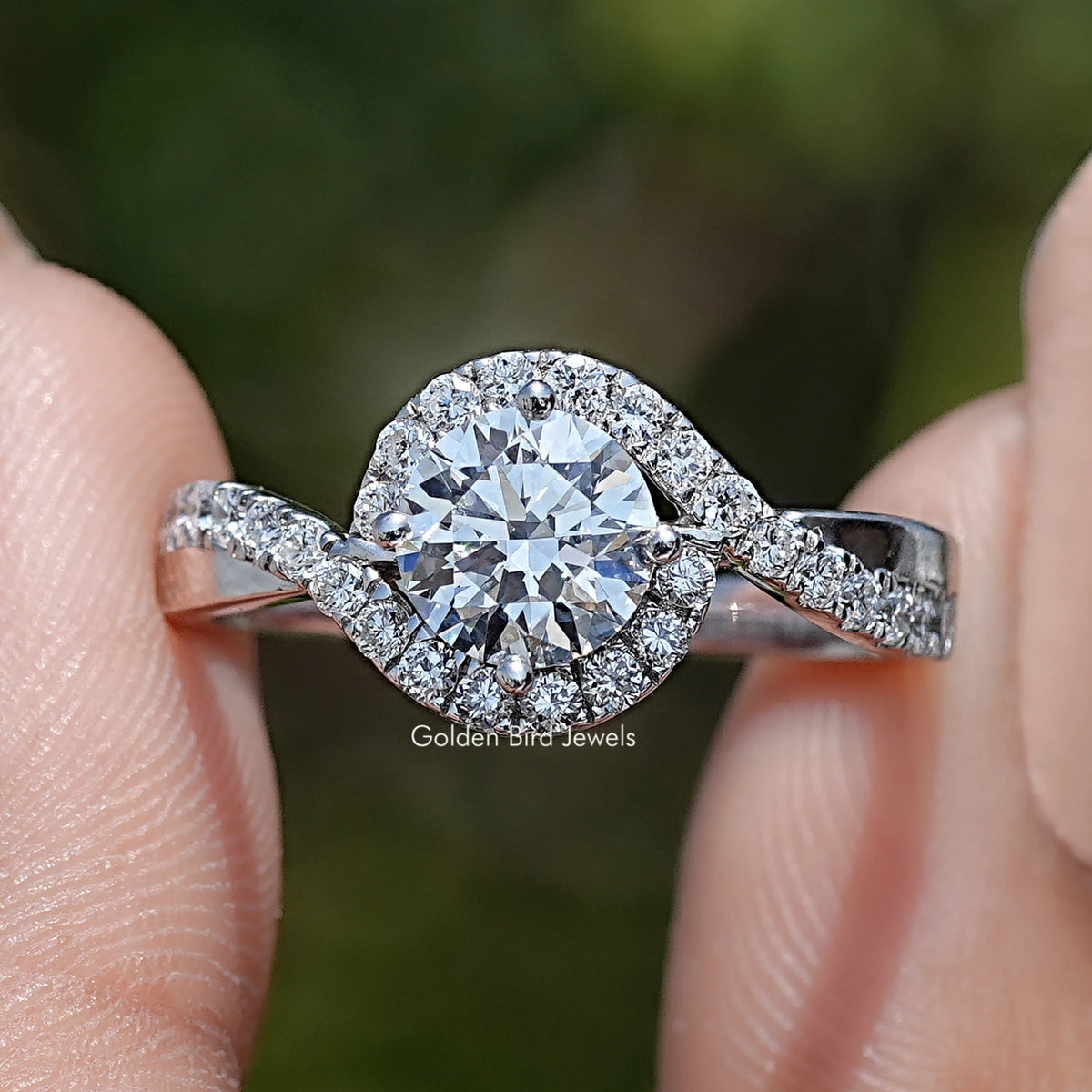 Round Cut Lab Grown Diamond Bypass Engagement Ring Held Between Fingers