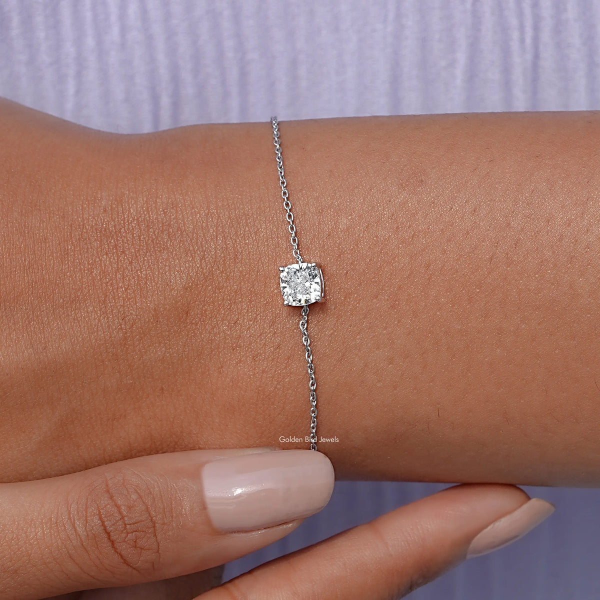 In hand view of cushion diamond chain bracelet