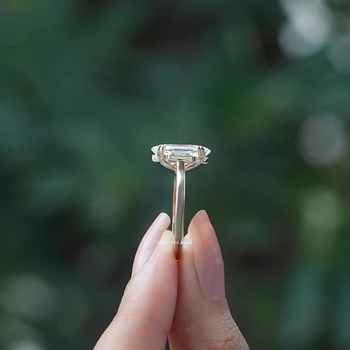 Side View of Step Cut Marquise Diamond Ring in two fingers