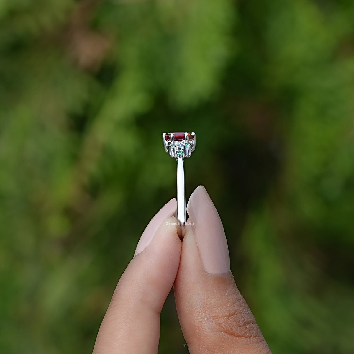 Side View of Hexagon Cut Gemstone Accent Ring In two fingers