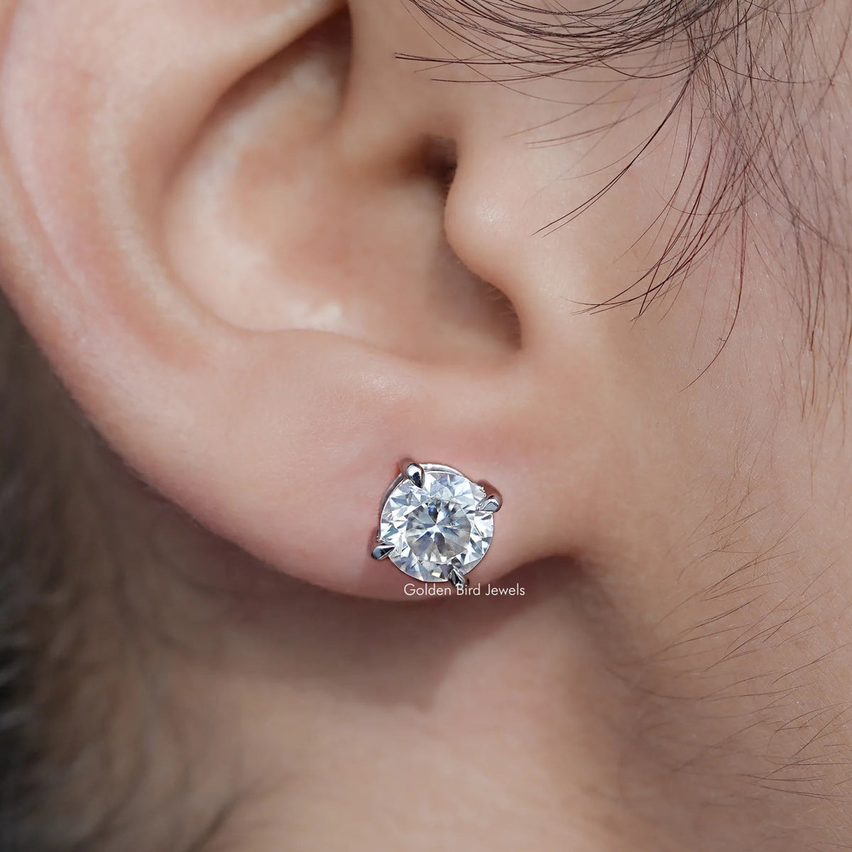In Ear View Of Round Cut Moissanite Stud Earrings in prongs setting