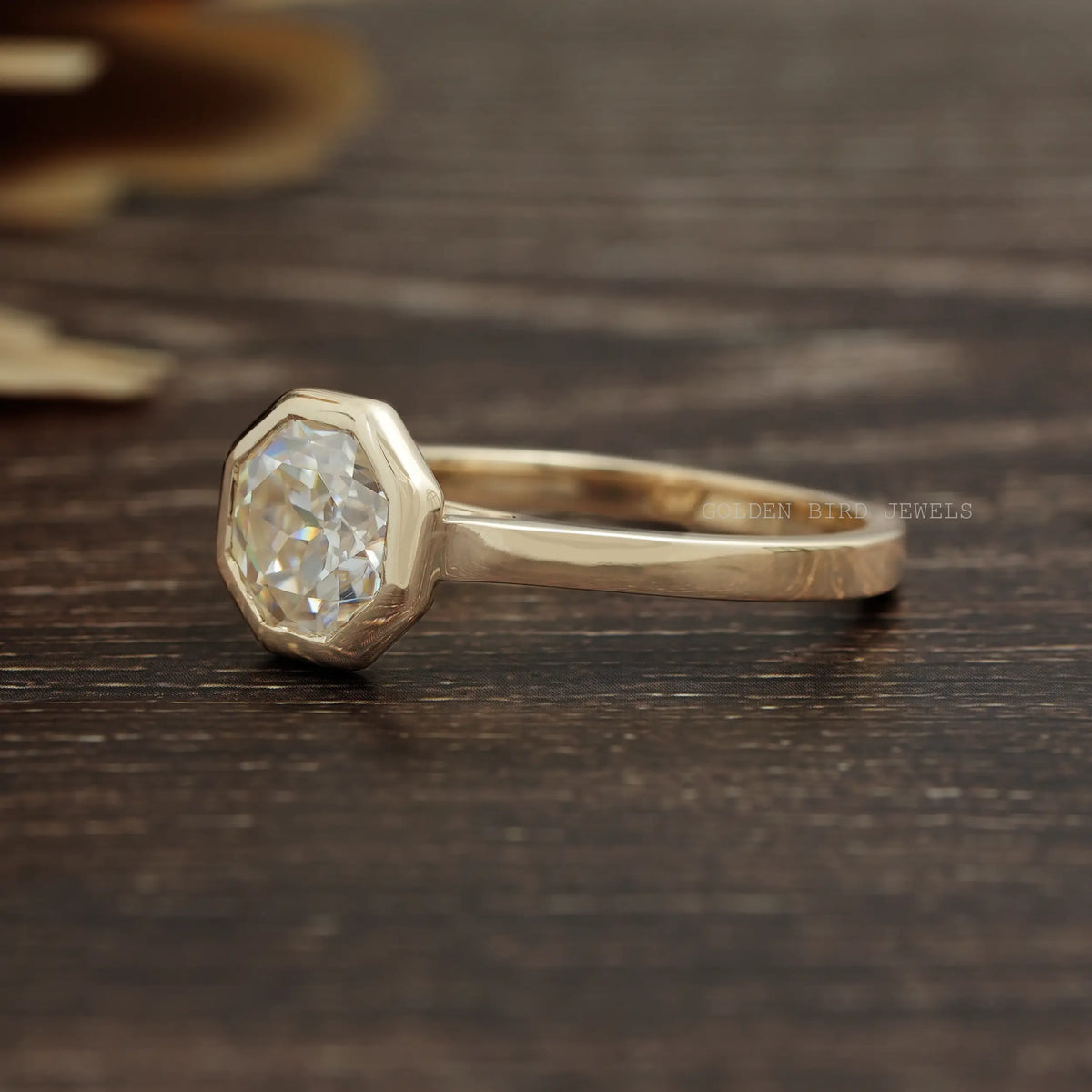 View of Bezel Set Octagon Cut Moissanite Solitaire Ring In Yellow Gold