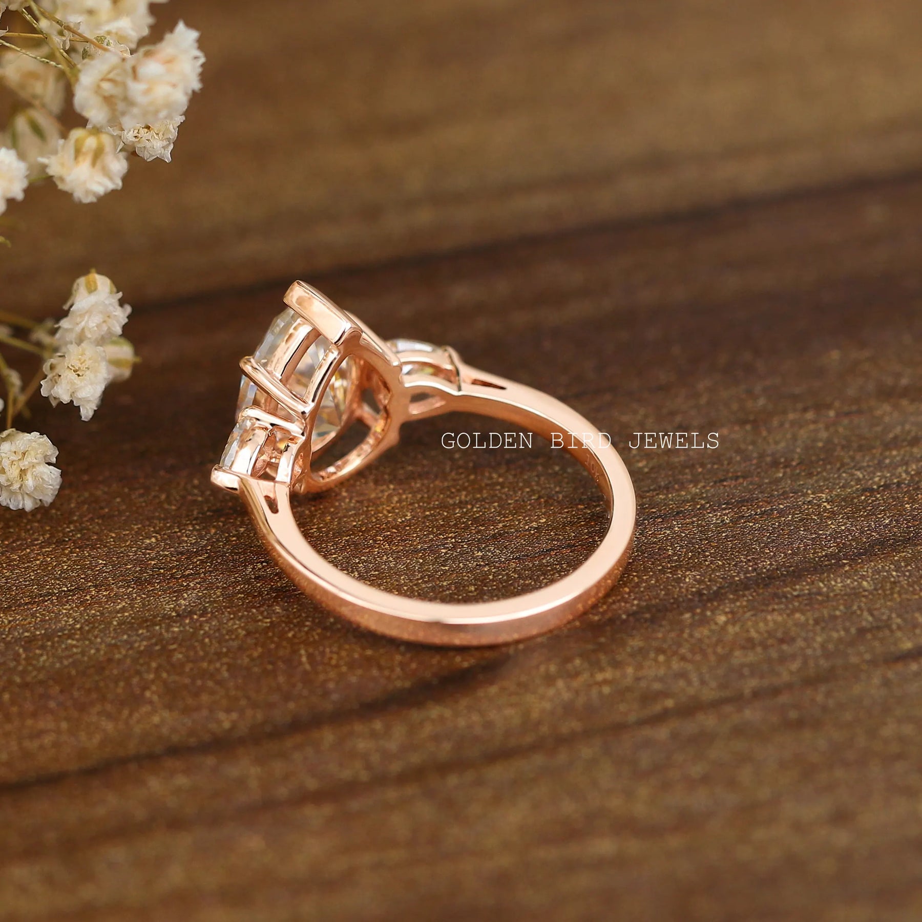 Back view of three-stone engagement ring crafted in unique secure design