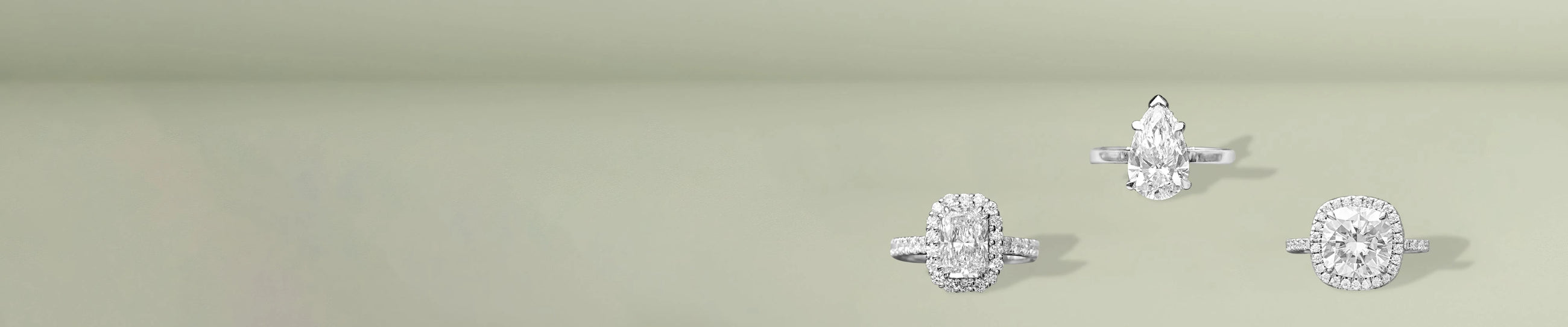 Lab grown diamond halo rings in elegant shapes displayed on soft green surface