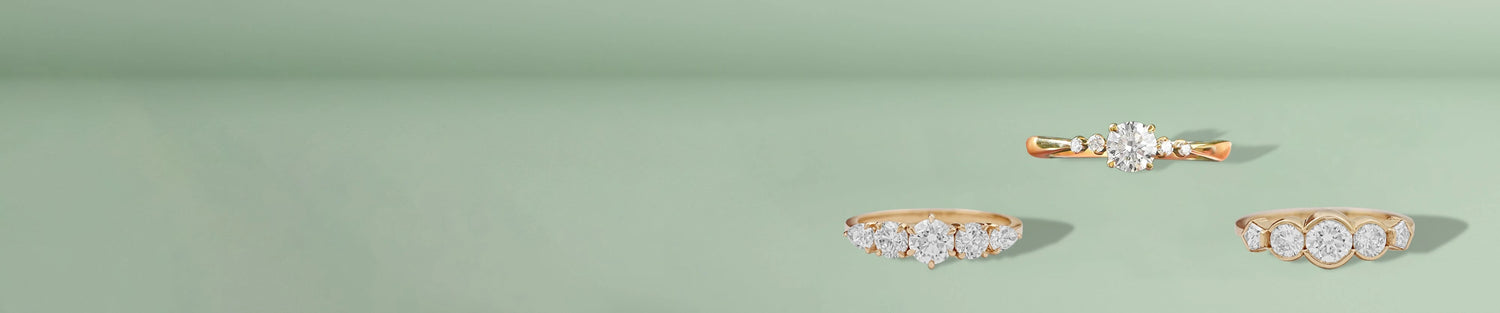 Lab grown five stone diamond ring displayed on classic blue background 