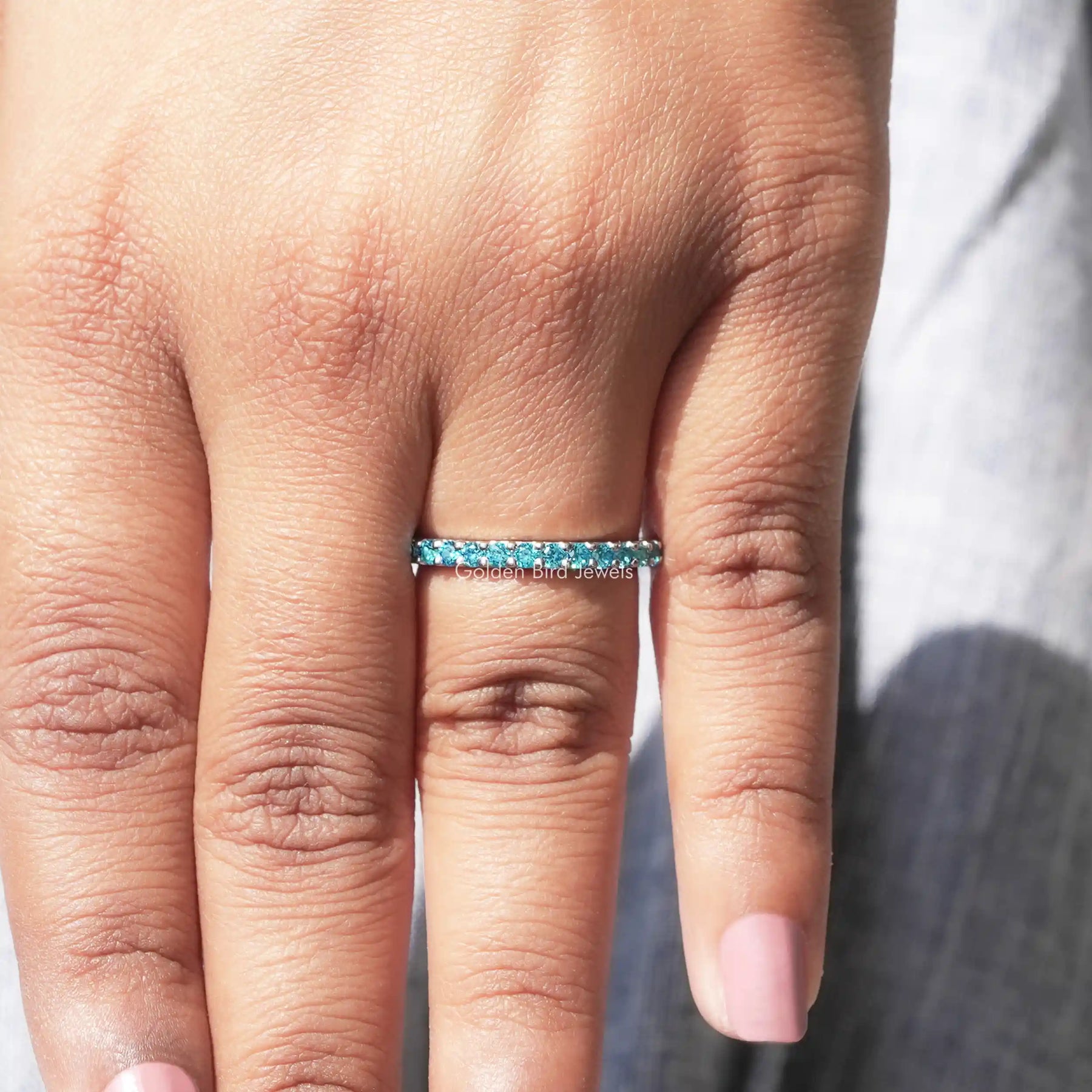 View of Blue Round Cut Moissanite Solitaire Ring in prongs setting 
