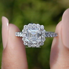 Front view of Asscher Cut Lab Diamond Accent Halo Wedding Ring in two fingers 