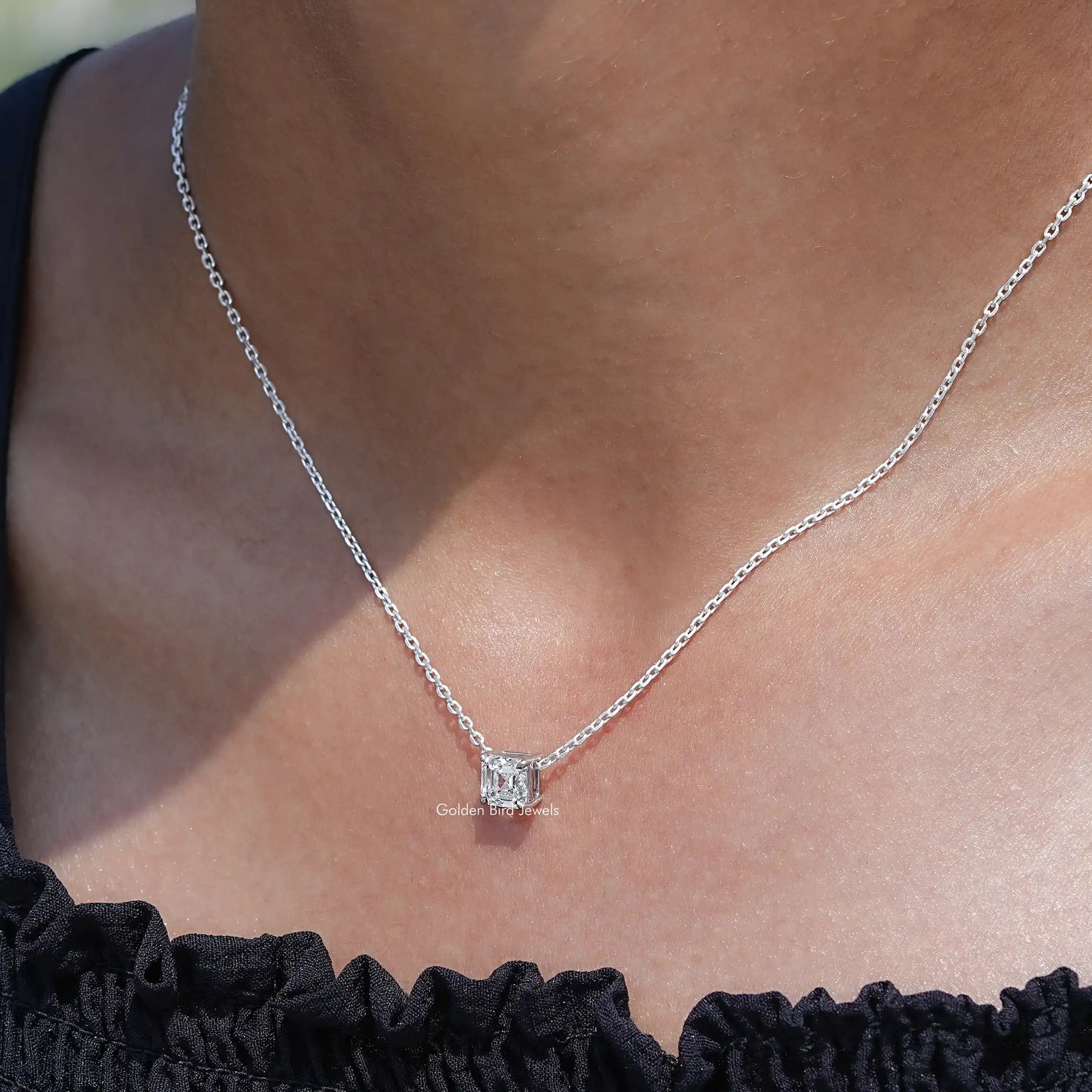 In neck view of Asscher cut diamond halo pendant 