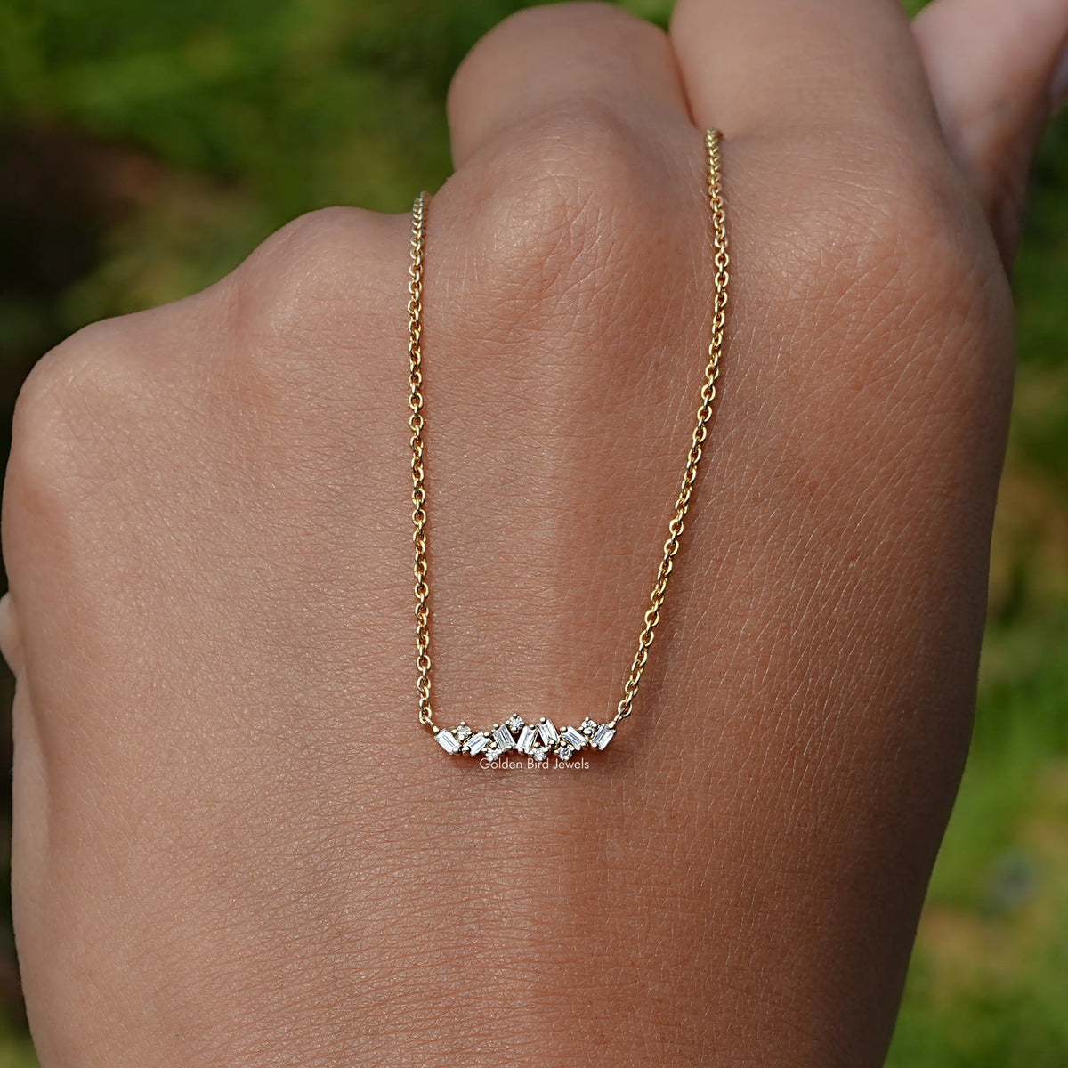 In Hand Holding in the Baguette Cut Diamond Cluster Pendant In Yellow Gold