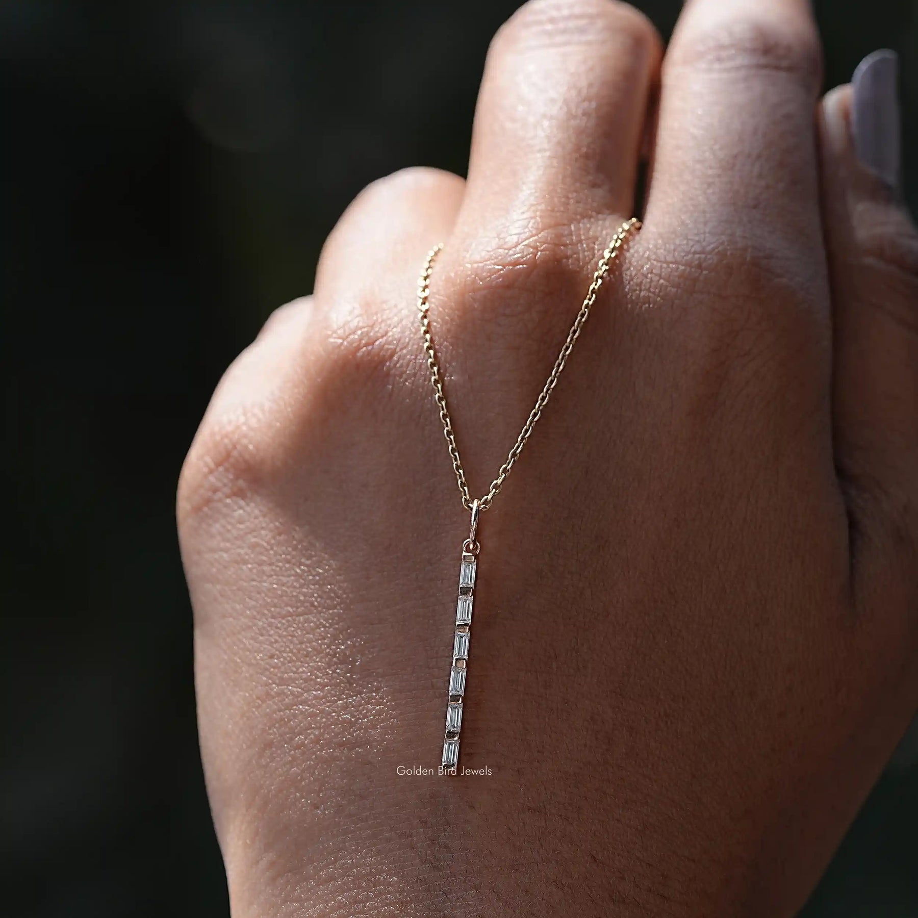 In hand showing view of moissanite pendant	 		