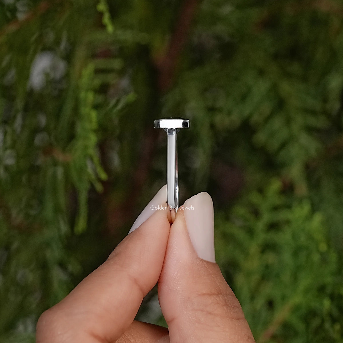 Side view of square radiant-cut gray moissanite solitaire ring in silver