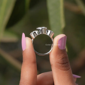 Back View of Three Stone Round Cut Moissanite Ring In two fingers