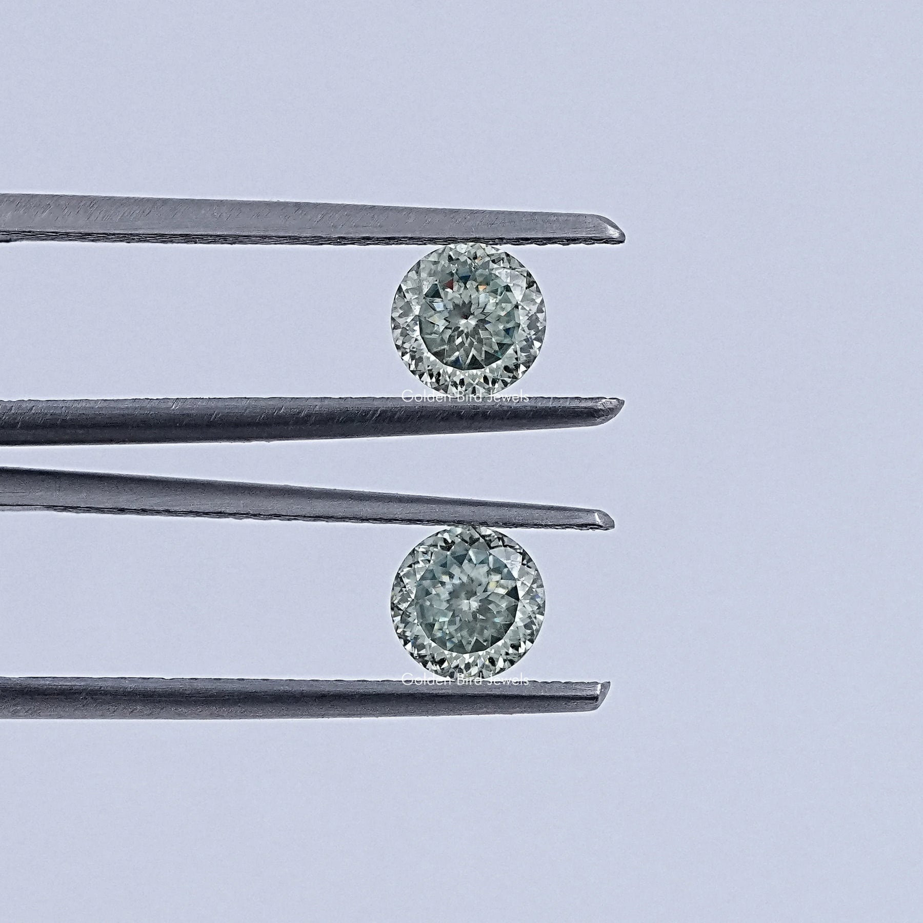 In Tweezer View Of Portuguese Cut Loose Moissanite Pair