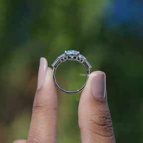 Back View of Pear Cut Lab Diamond Five Stone Ring In two fingers
