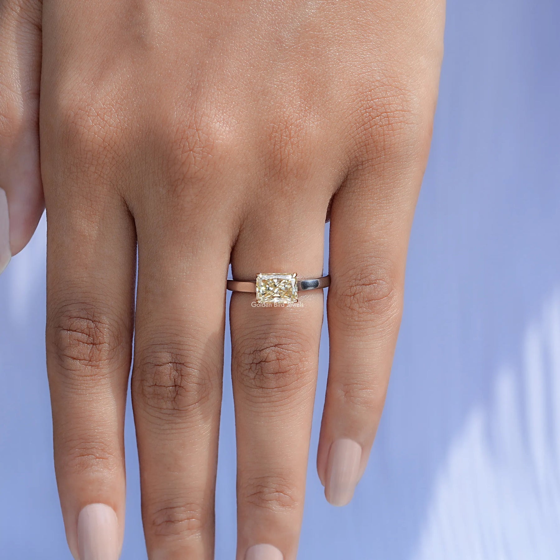 Top view of East West Yellow Radiant moissanite Solitaire Ring for women 's wear
