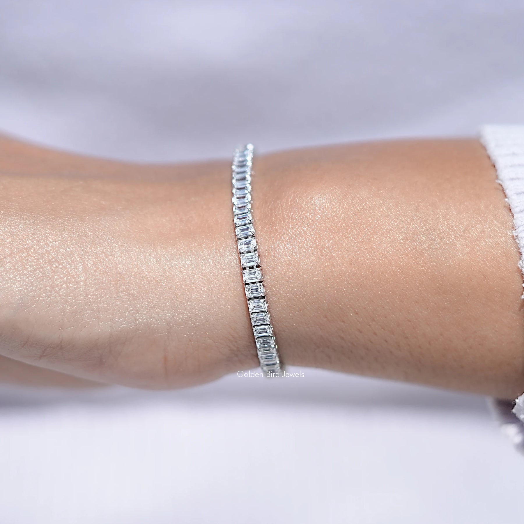 In hand Showing View Of Emerald Cut Lab Diamond Tennis Bracelet 