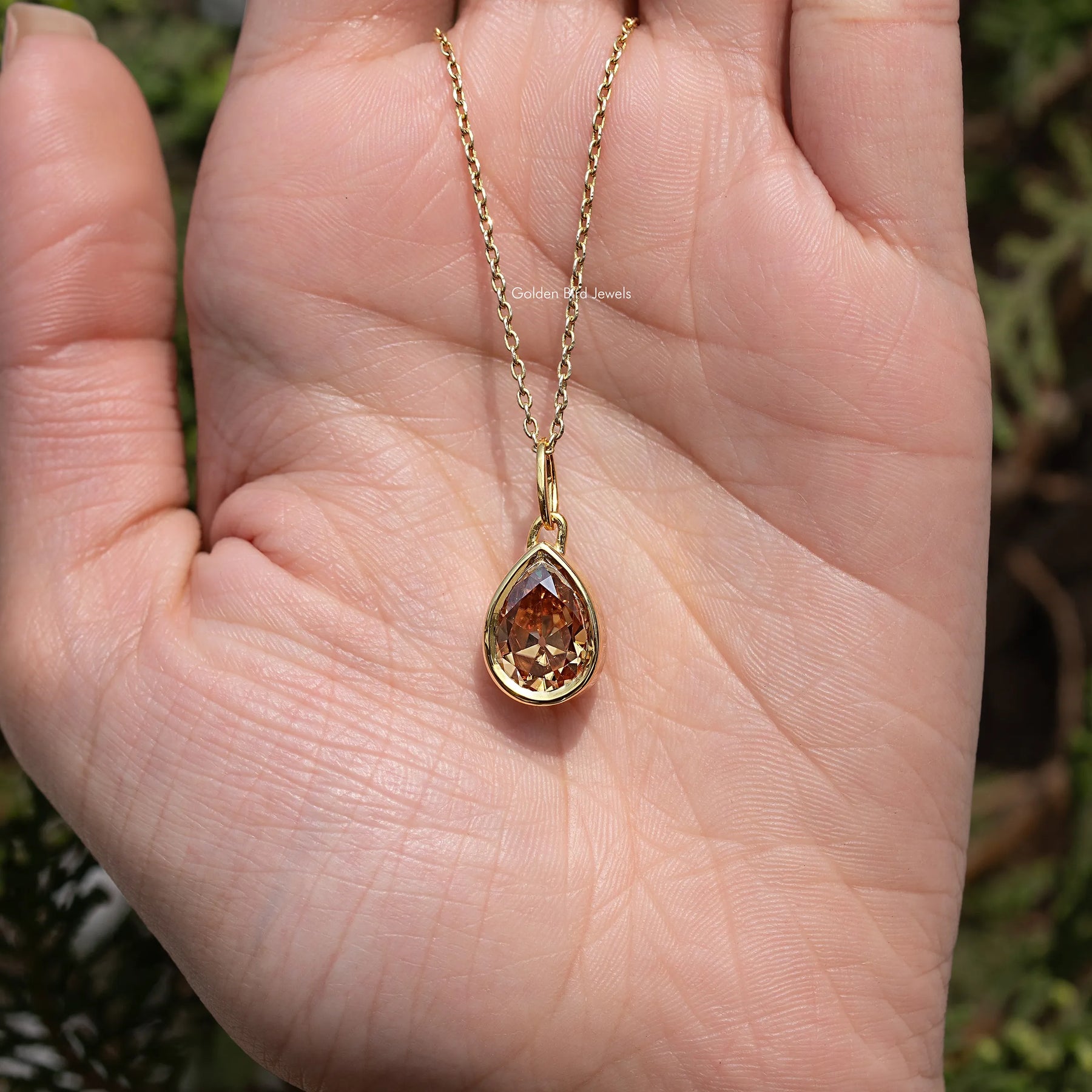 Close View Of Old Mine Pear Moissanite Pendant in Secure Setting 