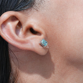 Detailed view of Solid Blue elongated cushion Cut Stud Earrings in secure setting