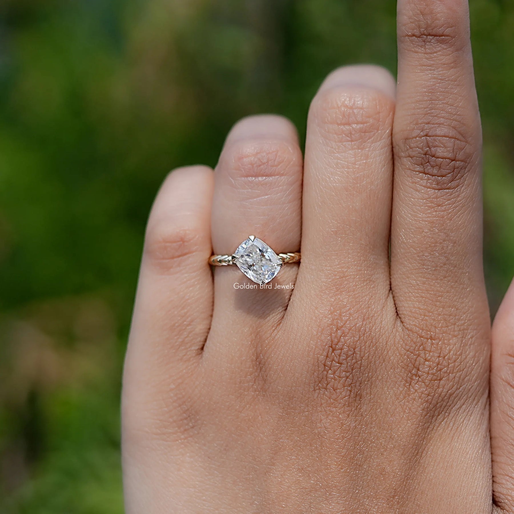 In finger front view of  Cushion Cut Moissanite engagement ring 