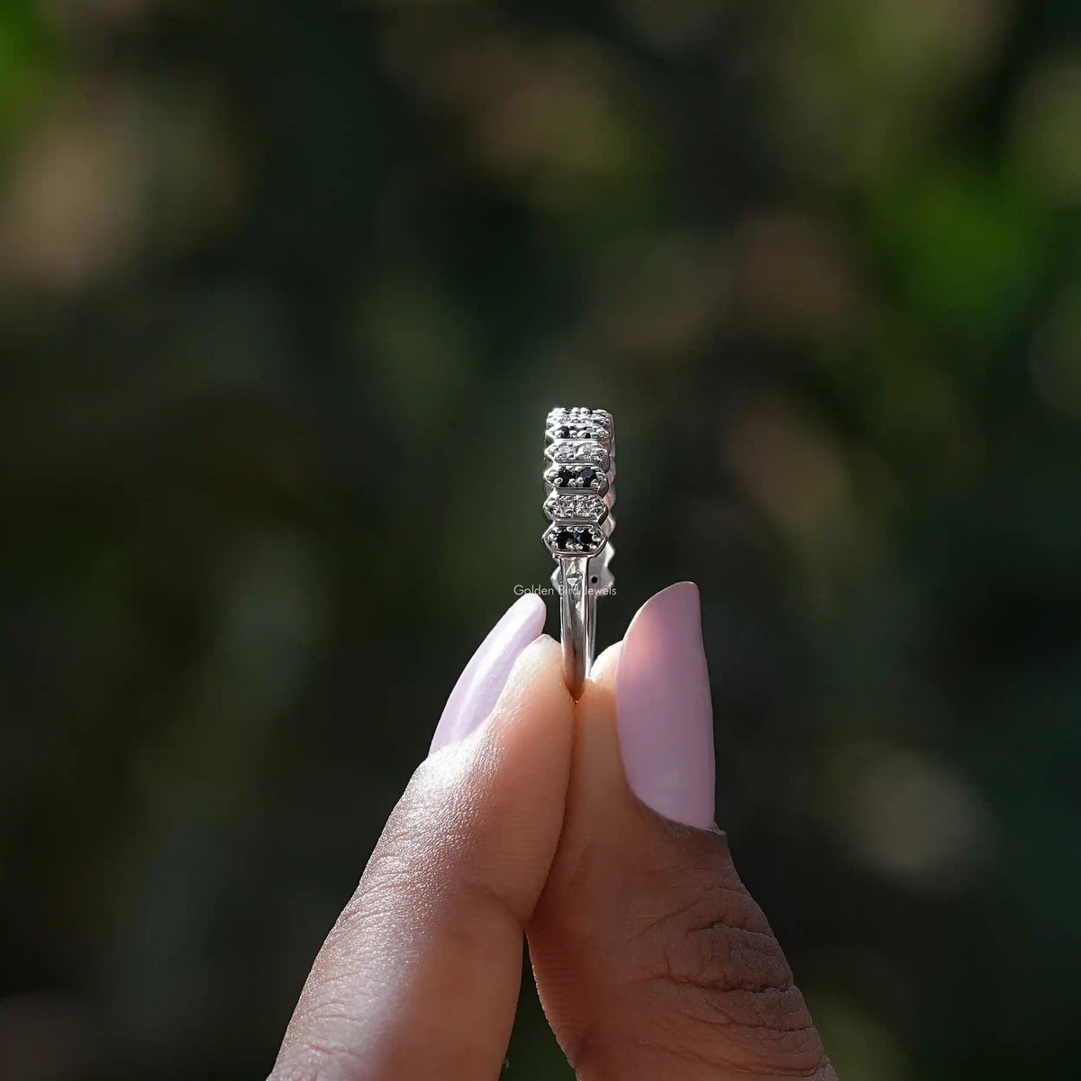 Side View of Round Cut Moissanite Eternity Band In two fingers