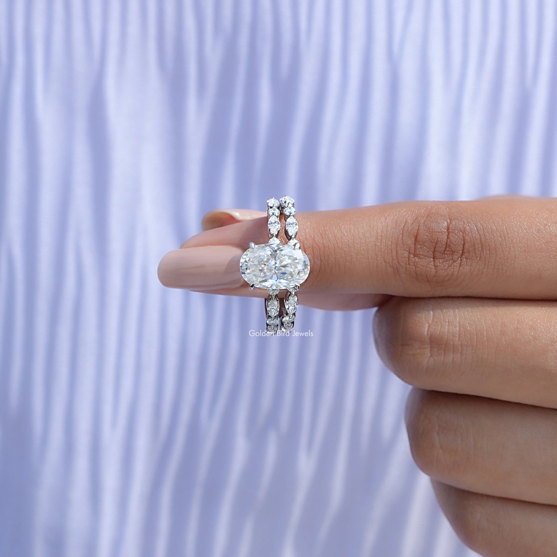 In finger front view of Crushed ice Oval Cut moissanite Bridal Set ring  in unique shape