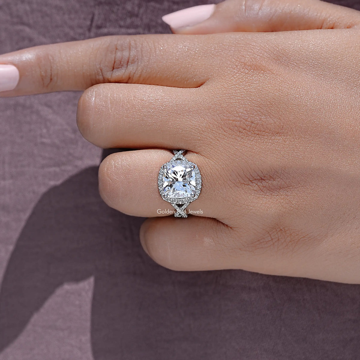 Round lab diamond solitaire with halo-style setting on a slim twisted band