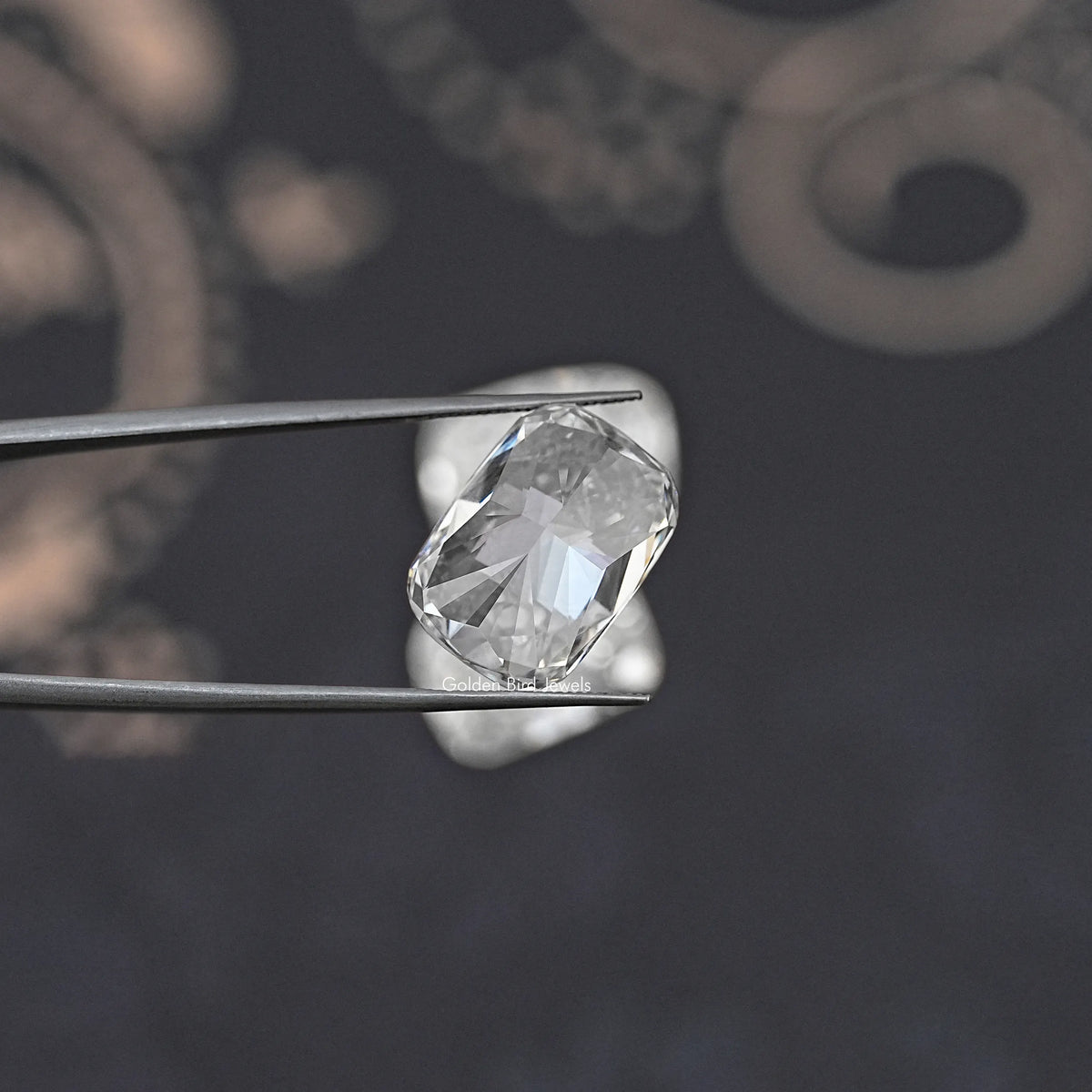 Elongated cushion-cut loose diamond on metal prongs, faceted