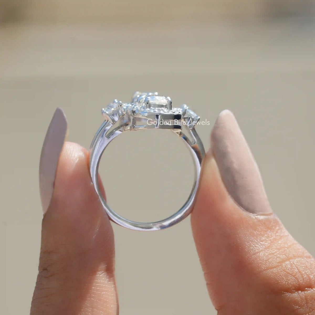 Back View of Moissanite Old Mine Cushion And Pear Cut Ring In two fingers