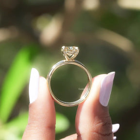 Back view of cushion cut moissanite  ring on holding two fingers 