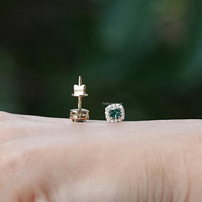 In hand view of moissanite stud earrings in unique shape
