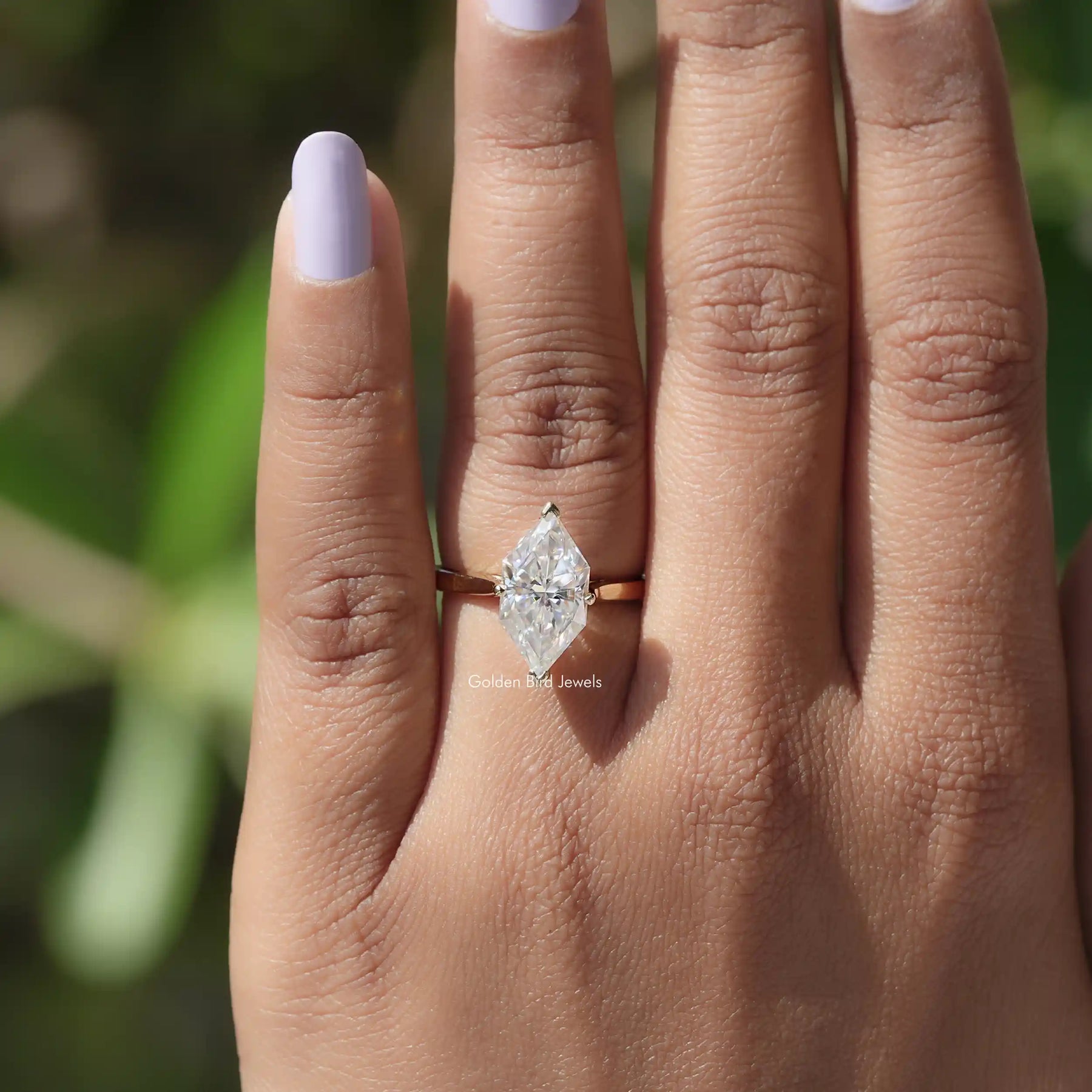 Close-up of 14k Yellow Gold Dutch Marquise Moissanite Ring on finger