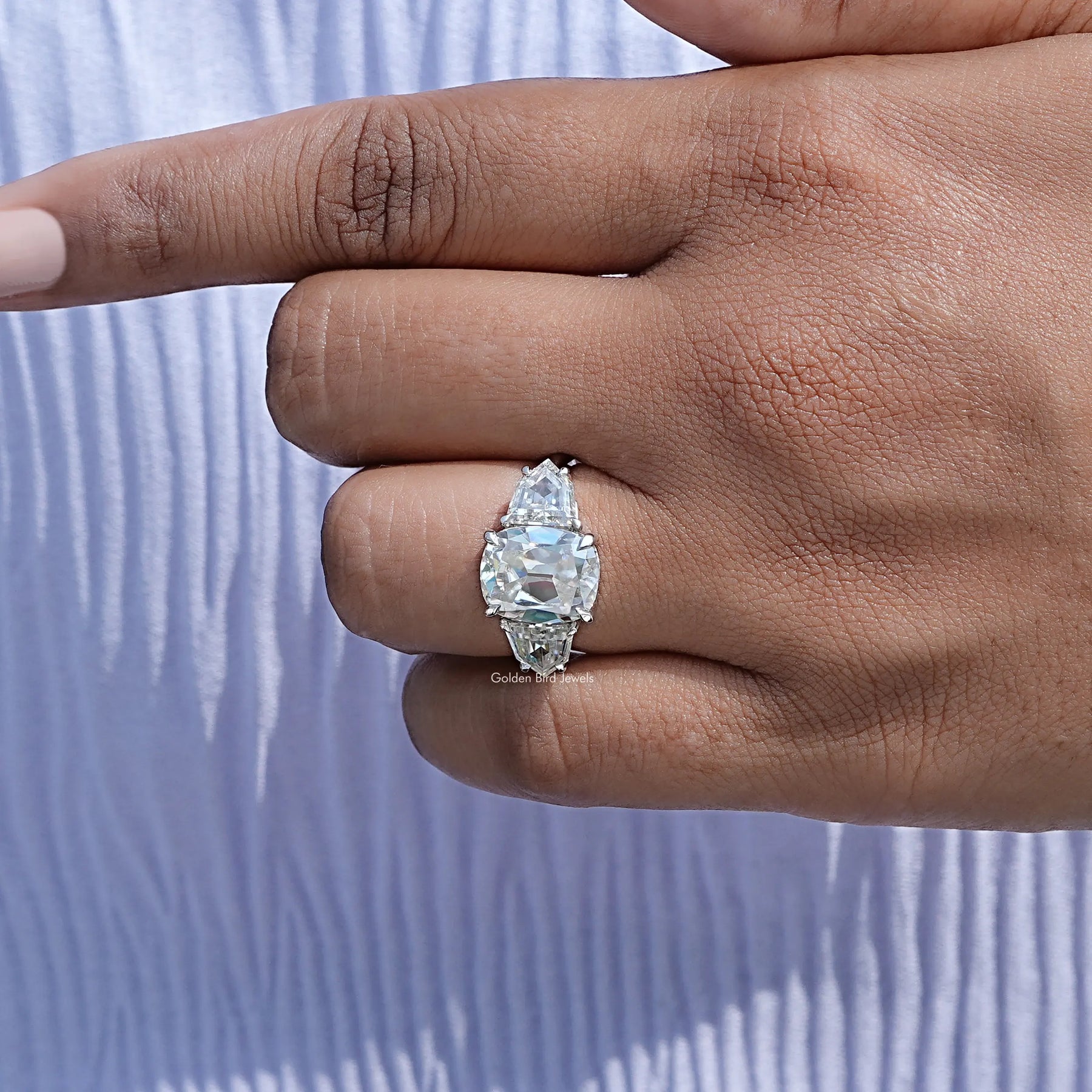 Close view of moissanite ring in secure setting 
