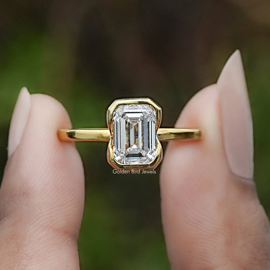 Emerald Cut Lab Diamond Bezel Set Solitaire Ring In Two Fingers