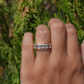 Close-Up View of Emerald Cut Diamond Bezel Set Eternity Band In Yellow Gold