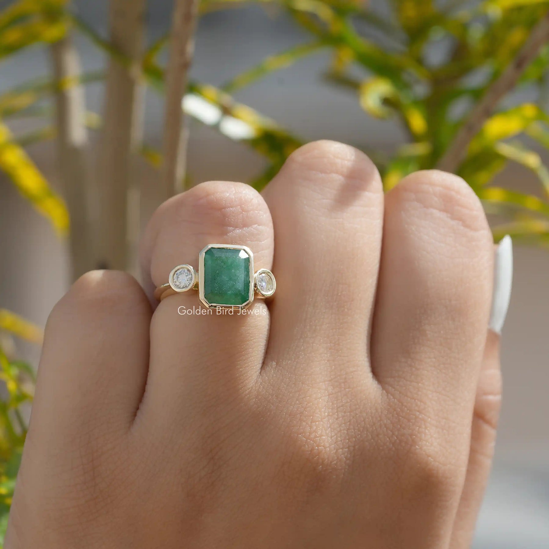 View Of Emerald Cut 3 Stone Ring In Yellow Gold