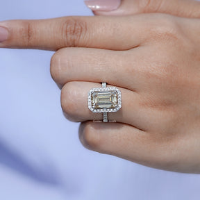 In finger front view of Emerald Cut moissanite wedding ring in unique shape