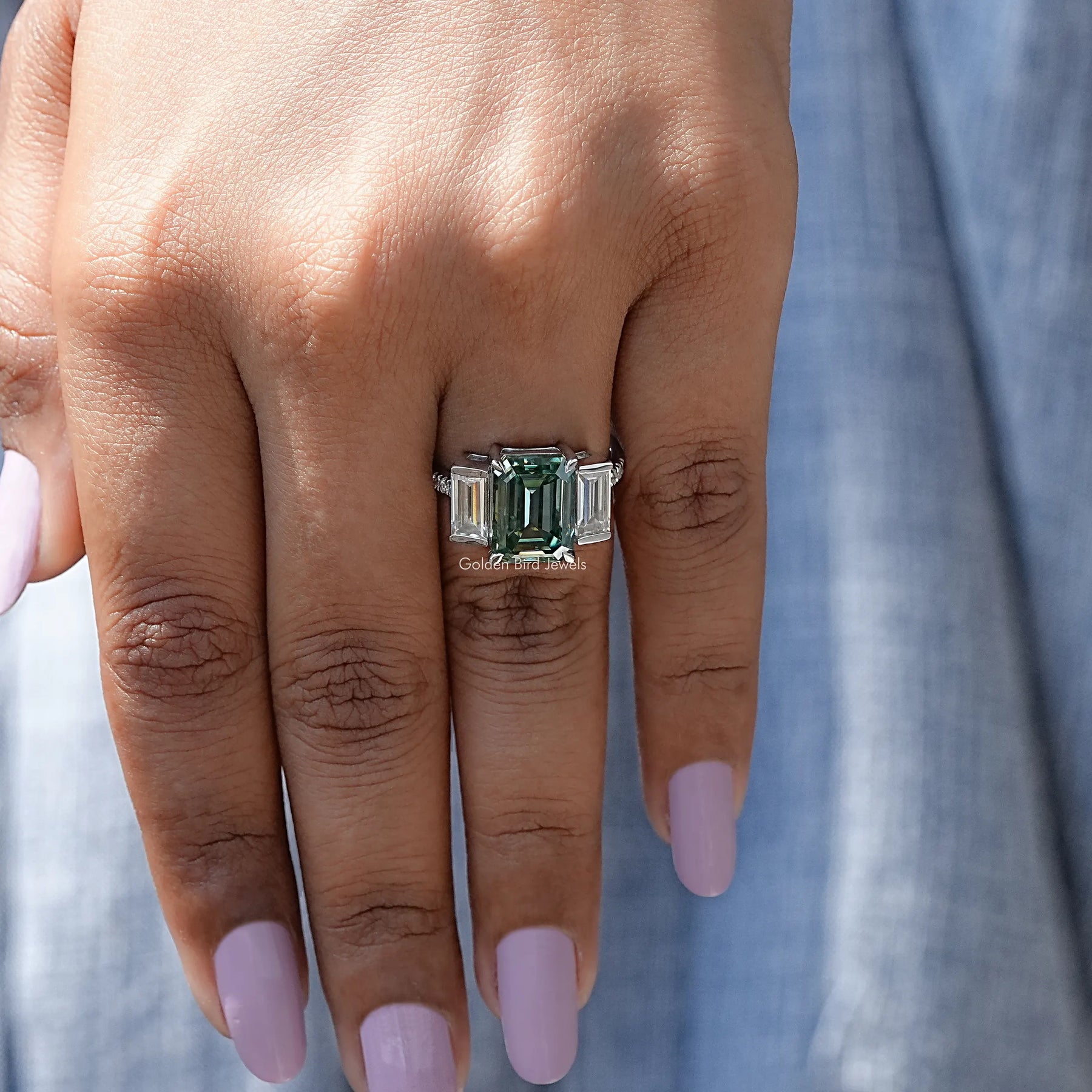 Front View of Emerald Cut Moissanite Three Stone In White Gold