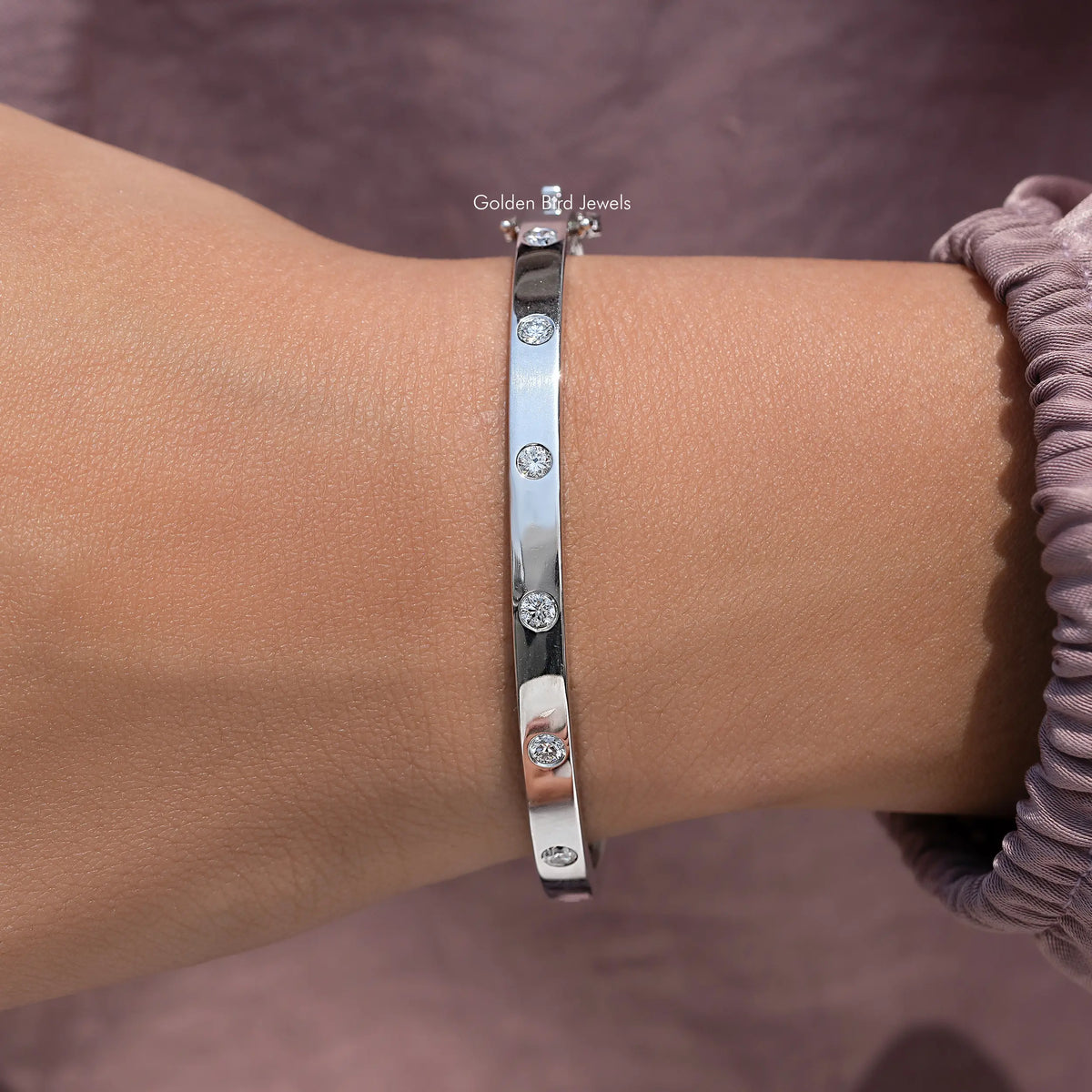 Silver round-cut lab diamond bangle, flush-set row on wrist, side angle