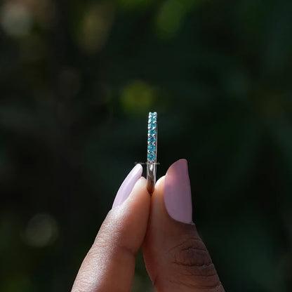 Side view of December Birthstone Blue Topaz Round Eternity Band