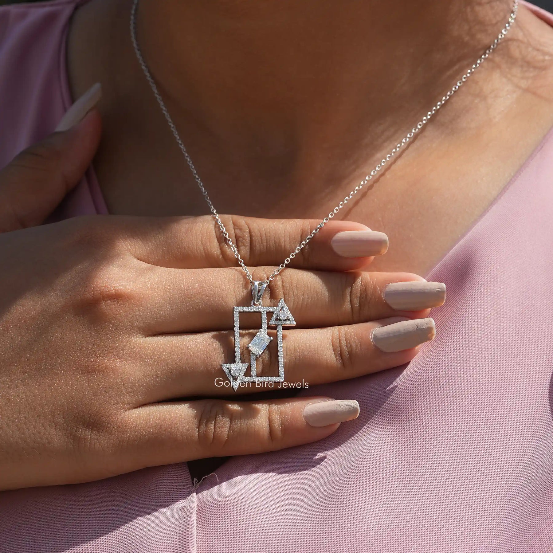 In hand showing view of moissanite pendant	 		