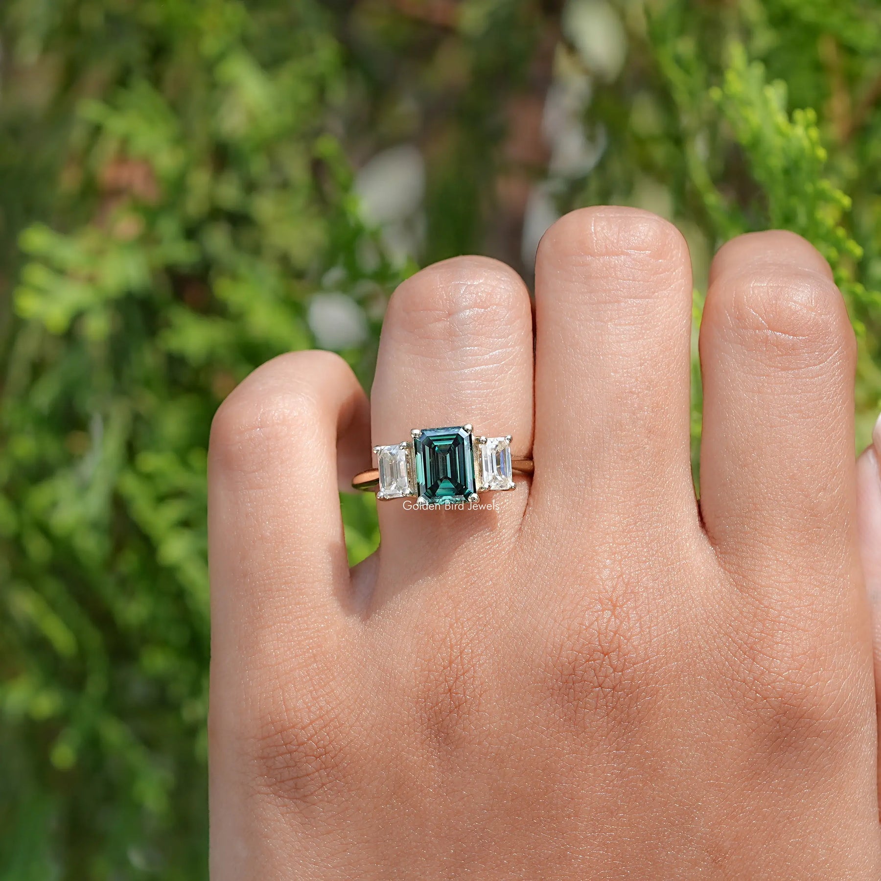 In Finger view of Emerald Moissanite 3 Stone engagement ring 
