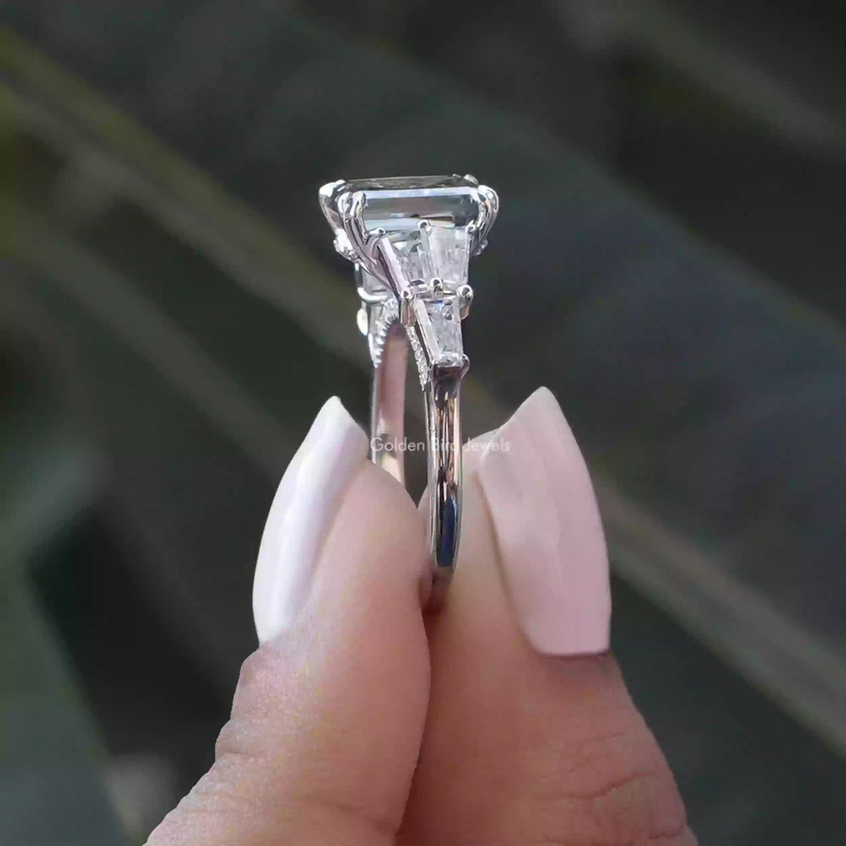 Side View of Criss Cut Two Stone Engagement Ring In two fingers