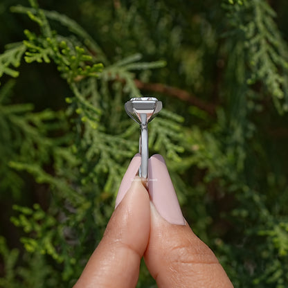 Side view of silver half-bezel solitaire ring showing radiant-cut stone profile