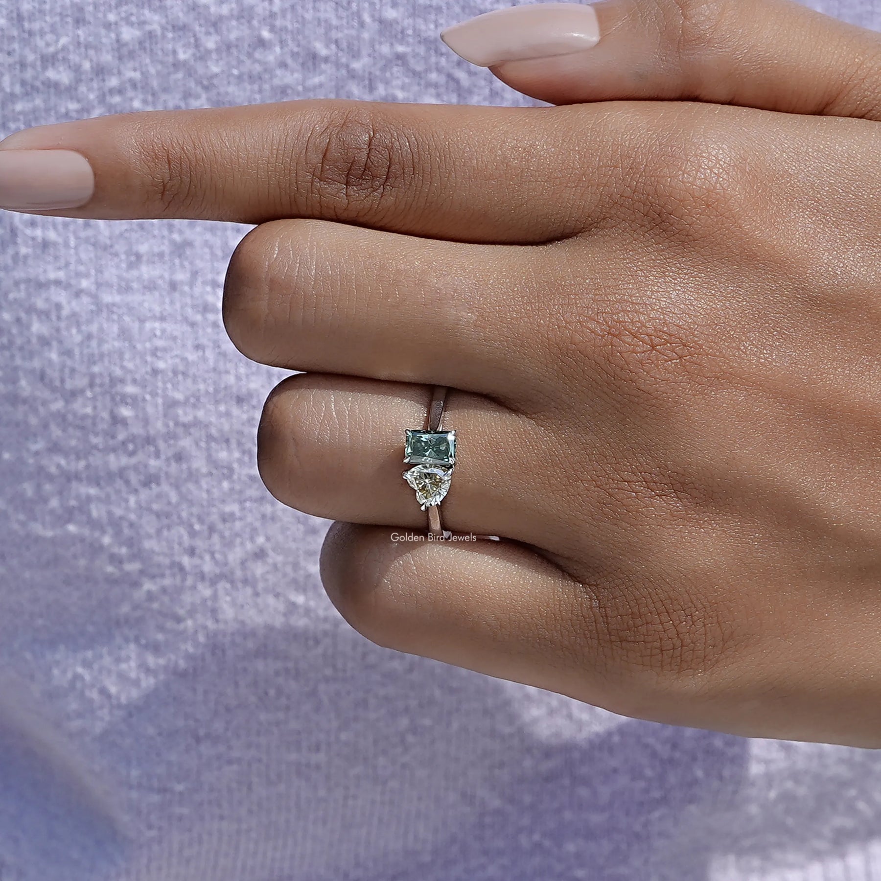 Close view of moissanite ring in secure setting 
