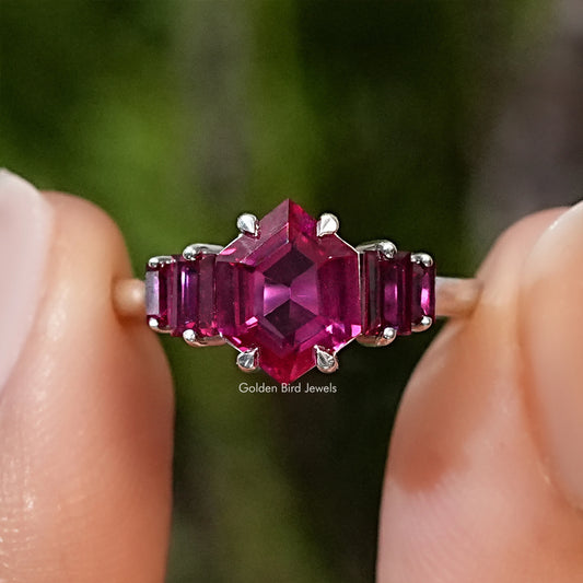 Five-stone ruby red hexagon-cut gemstone ring with prong-set side stones on silver band