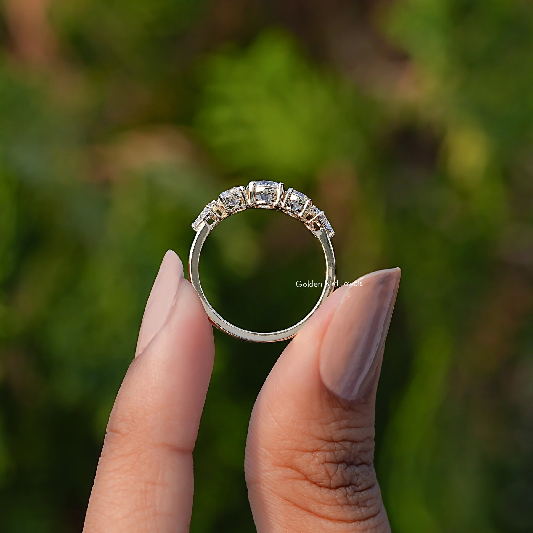Back View of Round Cut Lab Grown Diamond Five Stone Ring In two fingers