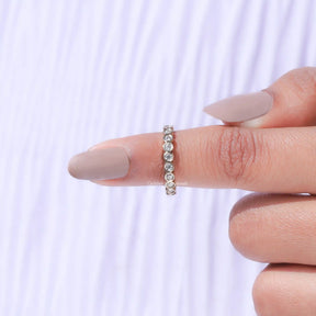 In finger front View of Round Cut Bezel Set Full Eternity Band In White Gold