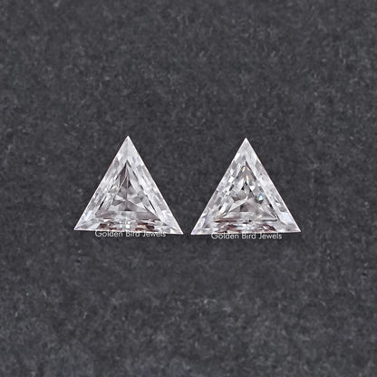 Two triangle-cut clear moissanite stones, faceted front view