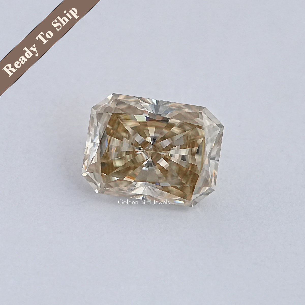 Radiant-cut moissanite gemstone in warm brown, faceted square shape